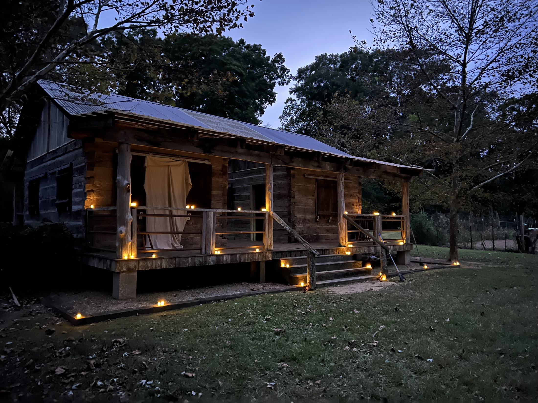 Sniteman Cabin glowing with candles at dusk