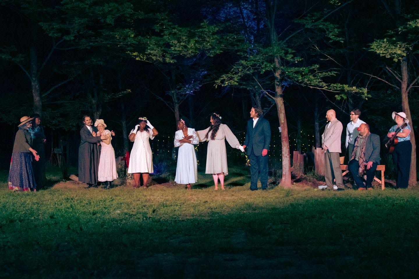 Performers dance together during an outdoor rehearsal